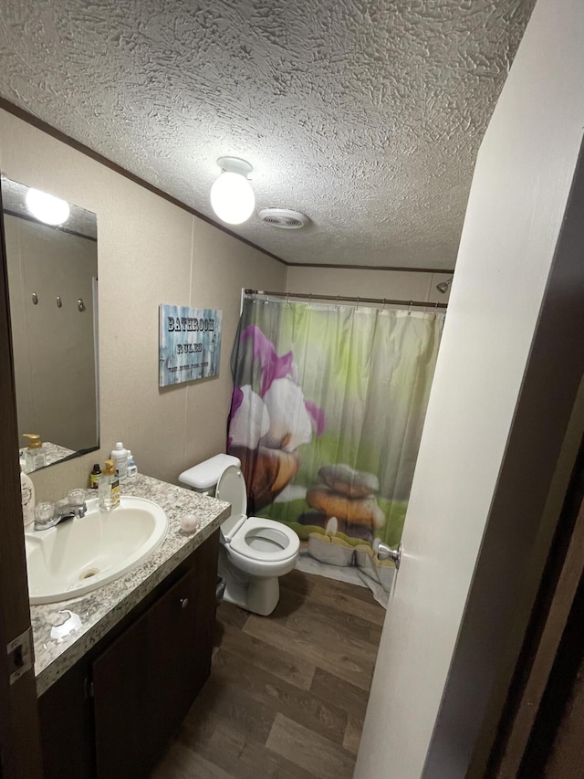 full bathroom with wood finished floors, vanity, toilet, a textured ceiling, and shower / bath combination with curtain