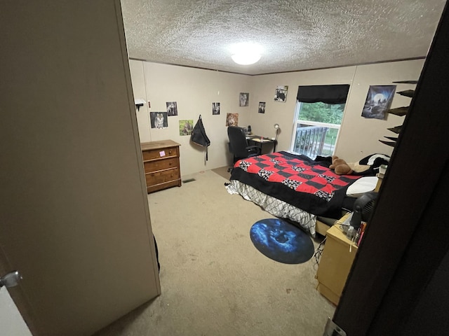 carpeted bedroom with a textured ceiling