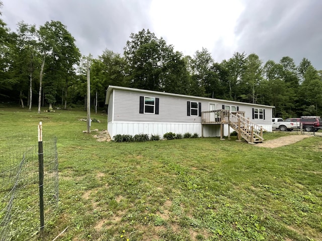 177 Gregory Branch Rd, Monticello, KY 42633 - manufactured / mobile home featuring a deck, stairway, a front yard, and view of wooded area