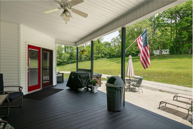 1335 Curtis Pike, Richmond, KY 40475 - wooden terrace featuring ceiling fan, a lawn, view of scattered trees, and outdoor dining area