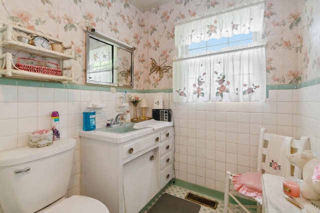 301 Vaught St, Somerset, KY 42501 - bathroom featuring wallpapered walls, tile walls, toilet, a wainscoted wall, and vanity