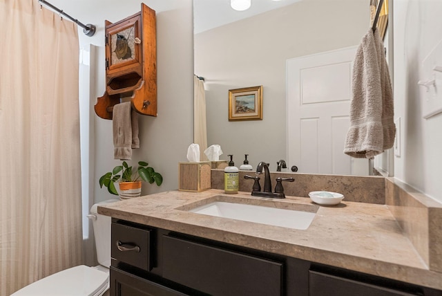 bathroom with vanity, toilet, and a shower with curtain