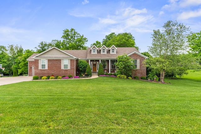 view of front of property with brick siding, a front lawn, and concrete driveway