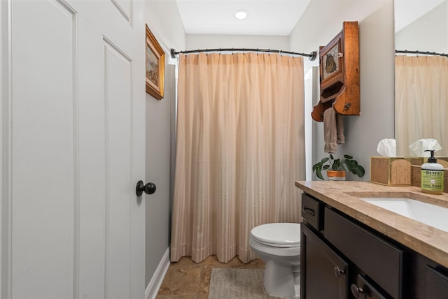 full bathroom featuring toilet, vanity, baseboards, and curtained shower