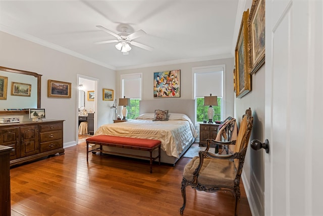 bedroom featuring multiple windows, ornamental molding, hardwood / wood-style floors, connected bathroom, and baseboards