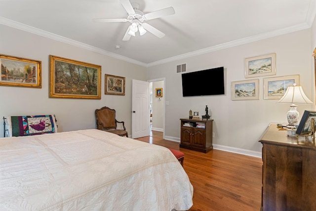 bedroom featuring wood finished floors, crown molding, baseboards, and ceiling fan