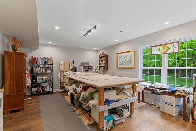 recreation room featuring wood finished floors, recessed lighting, and baseboards