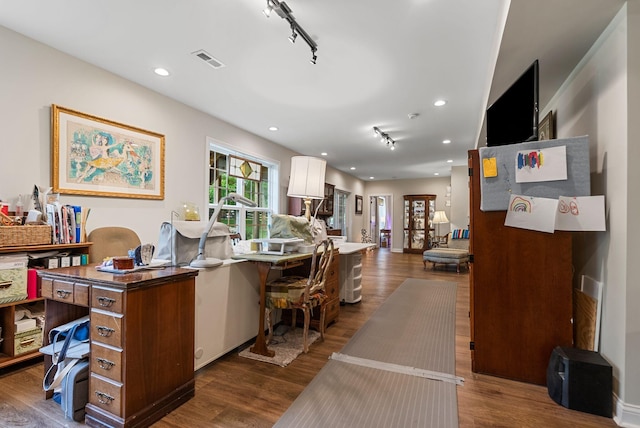 office featuring rail lighting, dark wood-style flooring, and recessed lighting