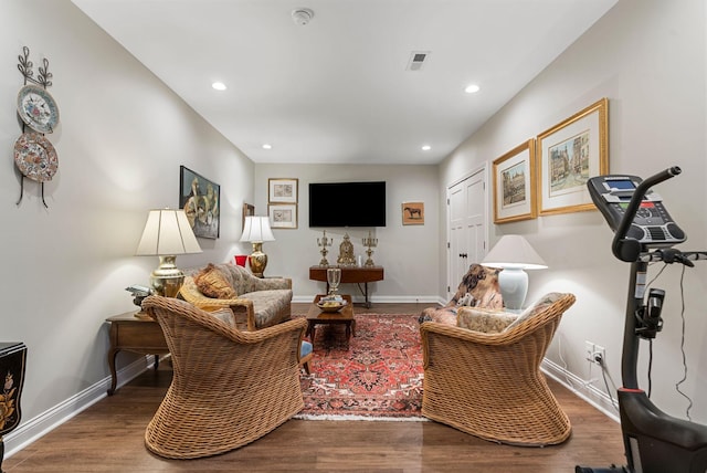 living room with wood finished floors, recessed lighting, and baseboards