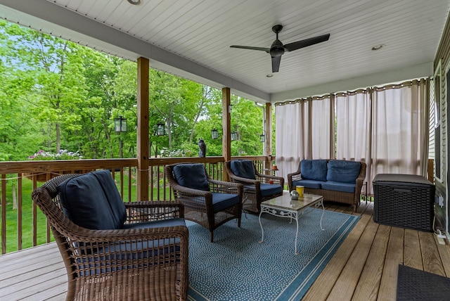 wooden deck with outdoor lounge area and a ceiling fan
