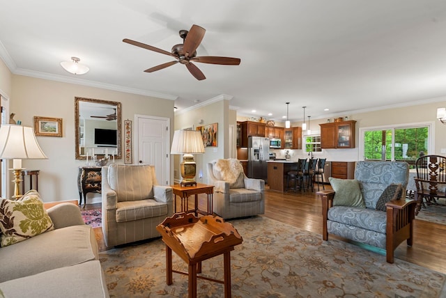 living room featuring a ceiling fan, wood finished floors, crown molding, and recessed lighting