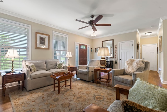 living room with plenty of natural light, wood finished floors, a ceiling fan, and crown molding