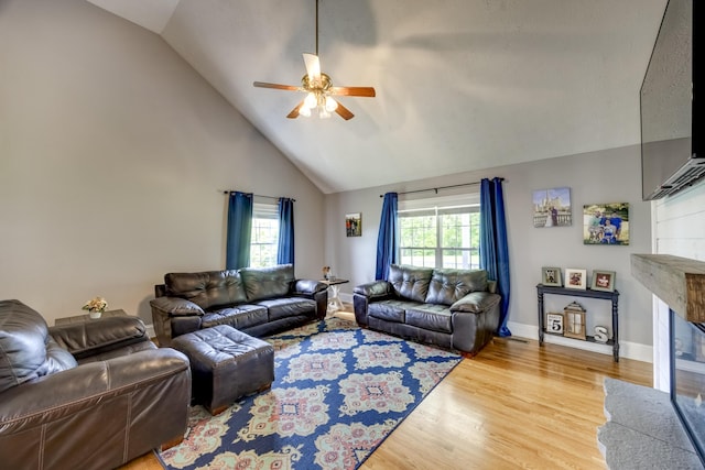 44 Gwinn Island Cir, Danville, KY 40422 - living area featuring a ceiling fan, a glass covered fireplace, wood finished floors, high vaulted ceiling, and baseboards