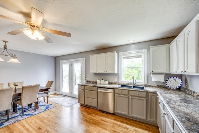44 Gwinn Island Cir, Danville, KY 40422 - kitchen featuring dishwasher, a sink, light wood-type flooring, white cabinets, and decorative light fixtures