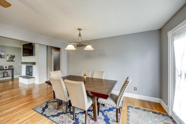 44 Gwinn Island Cir, Danville, KY 40422 - dining area featuring wood finished floors, baseboards, and a brick fireplace
