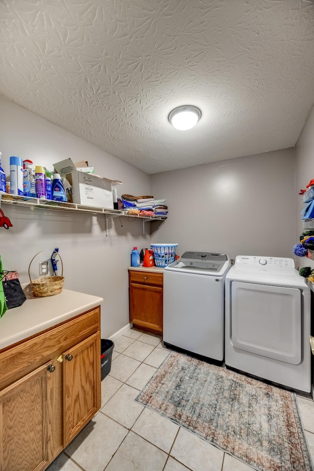 44 Gwinn Island Cir, Danville, KY 40422 - washroom with washer and dryer, cabinet space, light tile patterned flooring, and a textured ceiling