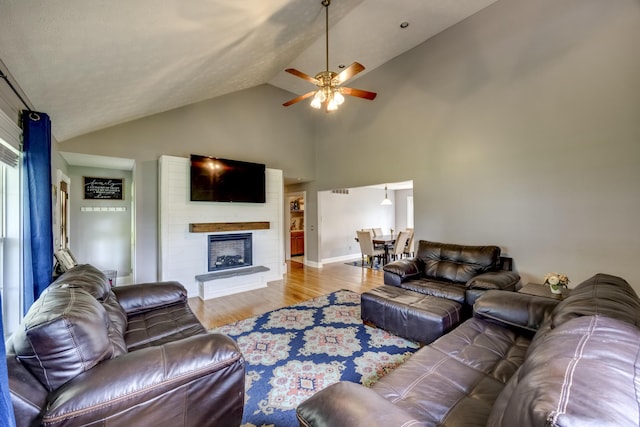44 Gwinn Island Cir, Danville, KY 40422 - living room with wood finished floors, a ceiling fan, a fireplace, high vaulted ceiling, and baseboards