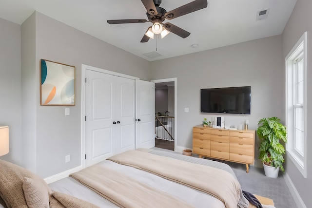 2269 Savannah Ln, Lexington, KY 40513 - carpeted bedroom with baseboards, multiple windows, a ceiling fan, and a closet
