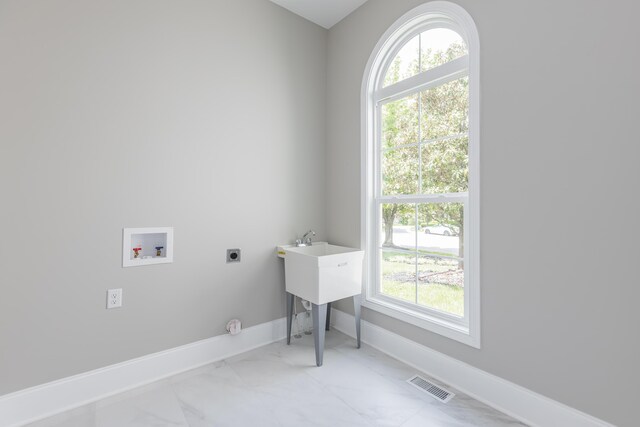 2269 Savannah Ln, Lexington, KY 40513 - laundry room with hookup for an electric dryer, hookup for a washing machine, plenty of natural light, and baseboards
