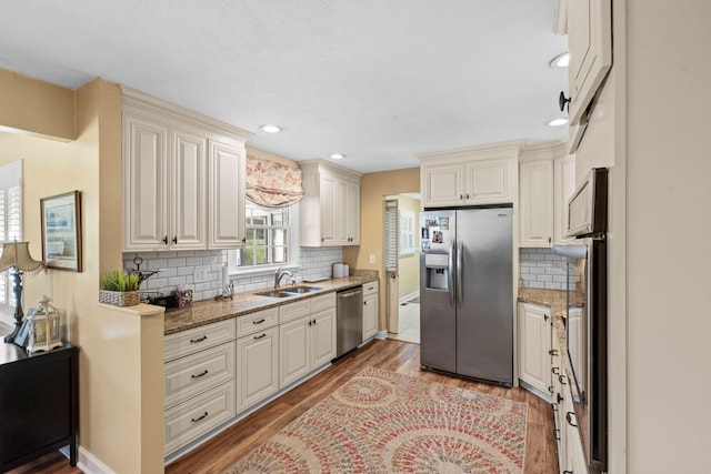 256 Michael Blvd, Frankfort, KY 40601 - kitchen with appliances with stainless steel finishes, a sink, light wood-style flooring, decorative backsplash, and light stone countertops