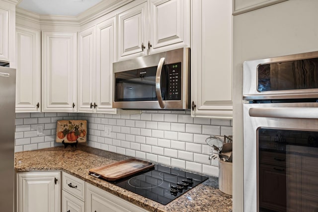 256 Michael Blvd, Frankfort, KY 40601 - kitchen featuring appliances with stainless steel finishes, white cabinetry, decorative backsplash, and dark stone counters