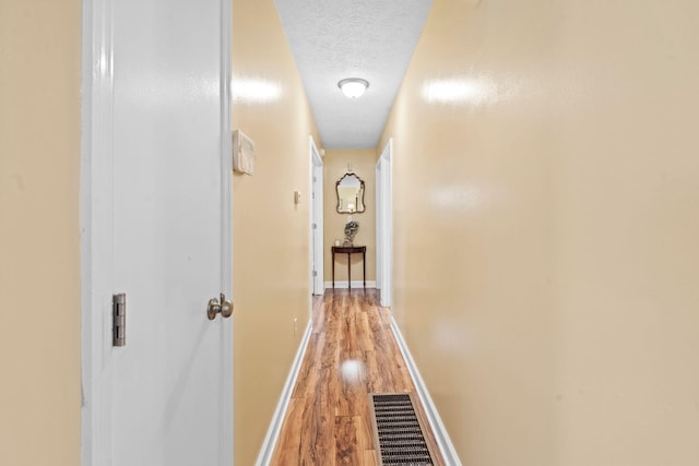 256 Michael Blvd, Frankfort, KY 40601 - hallway featuring light wood finished floors, baseboards, and a textured ceiling