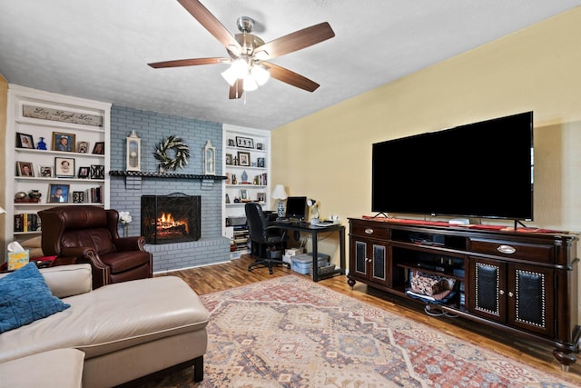 256 Michael Blvd, Frankfort, KY 40601 - living room featuring wood finished floors, ceiling fan, a fireplace, a desk, and a textured ceiling