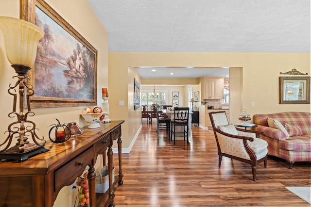 256 Michael Blvd, Frankfort, KY 40601 - living room with wood finished floors, a textured ceiling, a chandelier, and baseboards
