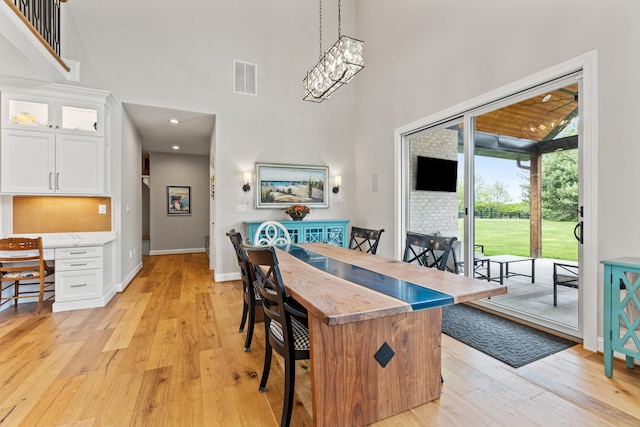 502 W Brannon Rd, Nicholasville, KY 40356 - dining area with a towering ceiling, light wood-type flooring, baseboards, recessed lighting, and a chandelier