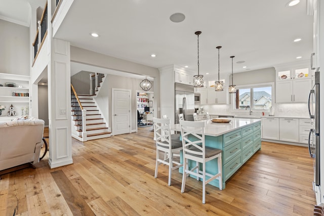 502 W Brannon Rd, Nicholasville, KY 40356 - kitchen featuring built in appliances, white cabinetry, light countertops, a kitchen breakfast bar, and backsplash