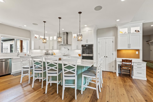 502 W Brannon Rd, Nicholasville, KY 40356 - kitchen featuring stainless steel appliances, wall chimney exhaust hood, white cabinetry, tasteful backsplash, and recessed lighting