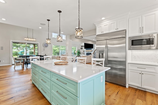 502 W Brannon Rd, Nicholasville, KY 40356 - kitchen with built in appliances, white cabinets, light wood-style flooring, recessed lighting, and decorative light fixtures