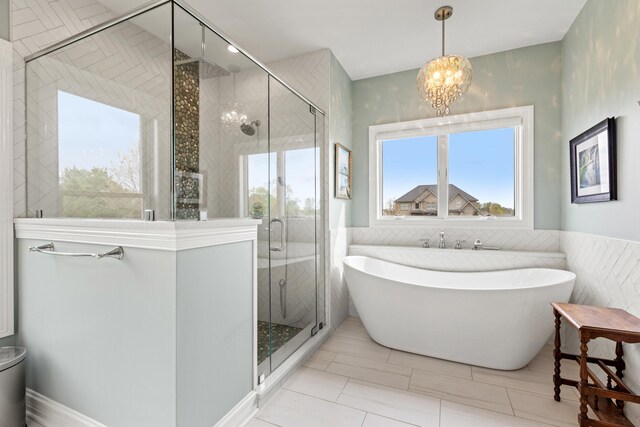 502 W Brannon Rd, Nicholasville, KY 40356 - full bathroom featuring a chandelier, a soaking tub, a stall shower, wainscoting, and tile walls