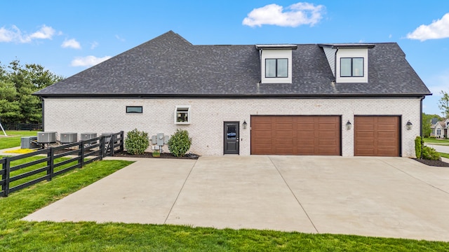502 W Brannon Rd, Nicholasville, KY 40356 - view of side of home featuring central AC unit, driveway, brick siding, and roof with shingles