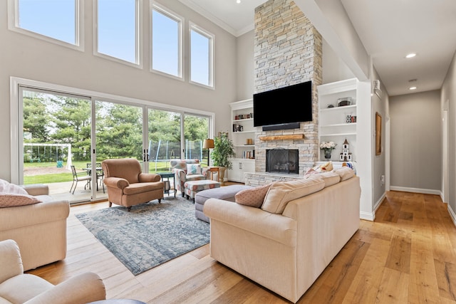 502 W Brannon Rd, Nicholasville, KY 40356 - living area featuring a stone fireplace, light wood finished floors, recessed lighting, a high ceiling, and crown molding