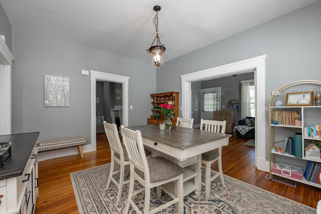 dining space with wood finished floors and baseboards