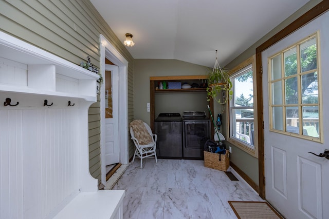 mudroom with vaulted ceiling, separate washer and dryer, light marble finish floors, and baseboards