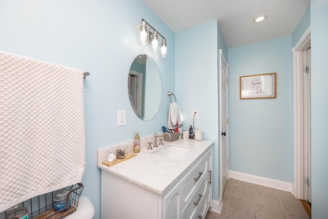 bathroom with tile patterned floors, vanity, and baseboards