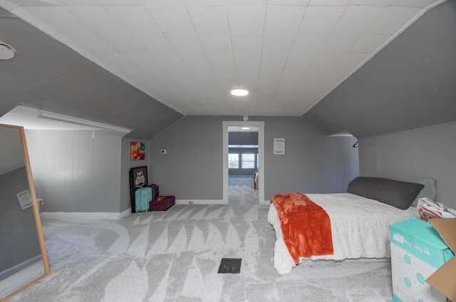 bedroom featuring carpet flooring, lofted ceiling, and baseboards