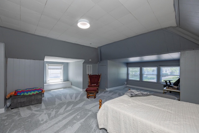 bedroom with lofted ceiling, carpet flooring, multiple windows, and baseboards