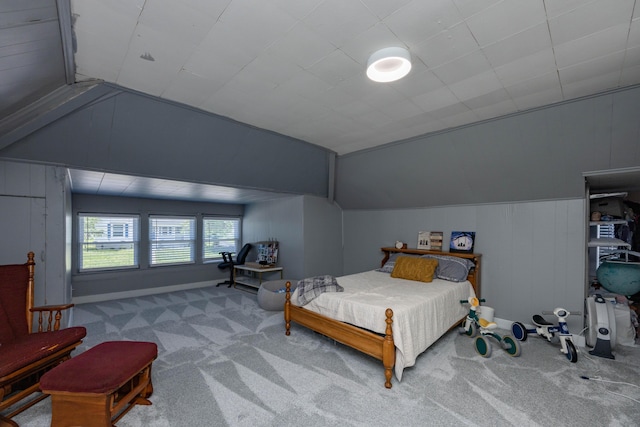 carpeted bedroom featuring lofted ceiling and baseboards