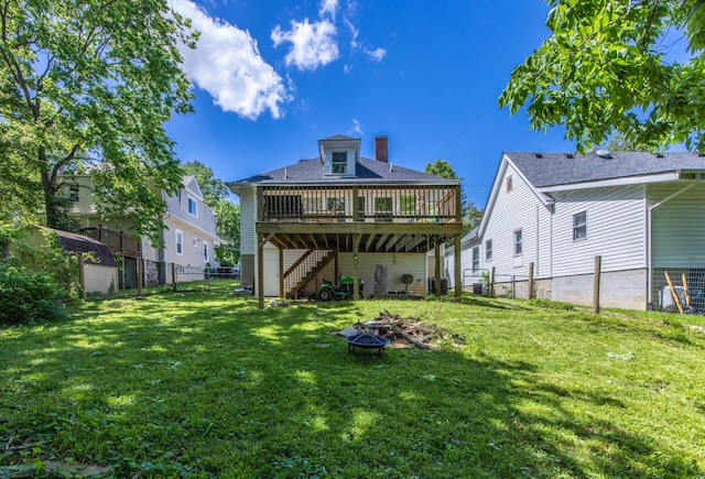 back of house featuring a fire pit, stairs, a deck, and a chimney
