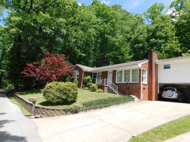 184 Meadow Dr, Harlan, KY 40831 - ranch-style house featuring brick siding, concrete driveway, a front lawn, a chimney, and a carport