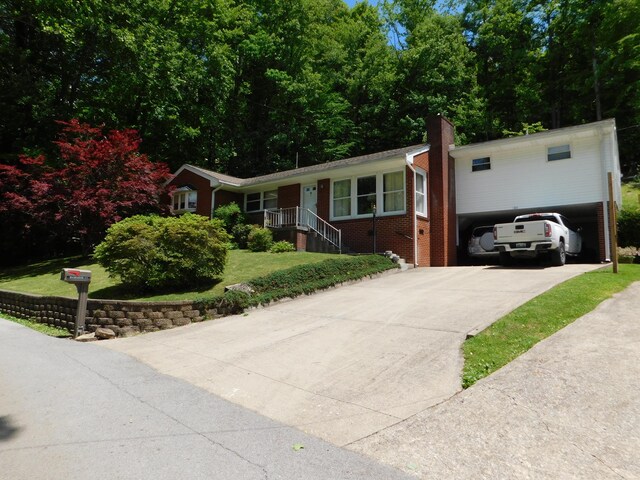 184 Meadow Dr, Harlan, KY 40831 - ranch-style house with concrete driveway, a front lawn, brick siding, and a chimney