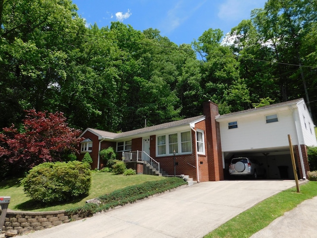 184 Meadow Dr, Harlan, KY 40831 - view of front of property featuring driveway, brick siding, a front yard, and a chimney