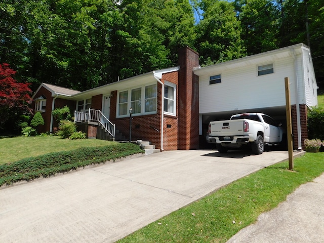 184 Meadow Dr, Harlan, KY 40831 - view of front of home featuring brick siding, driveway, a front yard, and a chimney