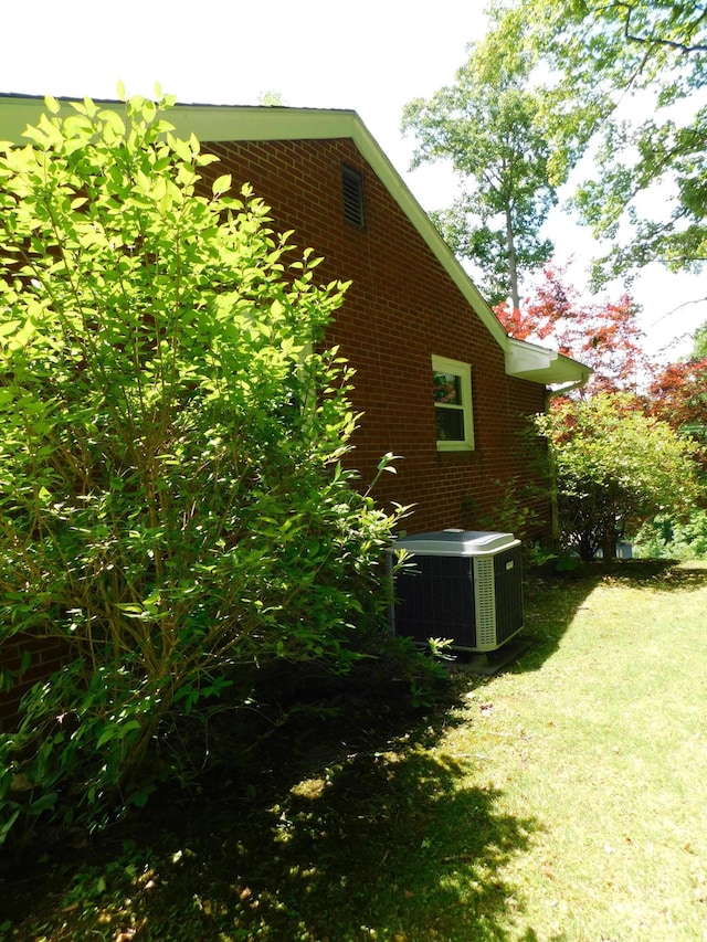 184 Meadow Dr, Harlan, KY 40831 - view of side of property with cooling unit, brick siding, and a yard