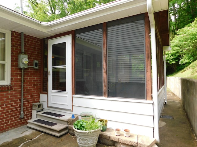 184 Meadow Dr, Harlan, KY 40831 - view of home's exterior with brick siding, entry steps, and a sunroom