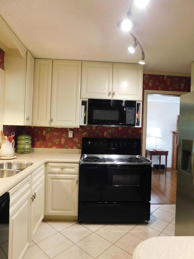 184 Meadow Dr, Harlan, KY 40831 - kitchen with black appliances, wallpapered walls, light countertops, light tile patterned floors, and a sink
