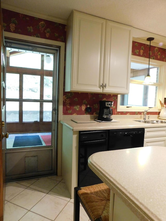 184 Meadow Dr, Harlan, KY 40831 - kitchen with black dishwasher, wallpapered walls, white cabinetry, light tile patterned floors, and light countertops